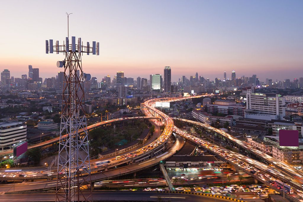 Telecommunication tower with 5G cellular network antenna on city